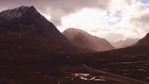 Aerial: Sun breaking through in Scottish glen (Glen Etive). 4K Stock Footage 103163314