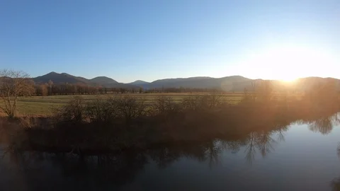 AERIAL Sun setting behind the hills Stock Footage 101074870