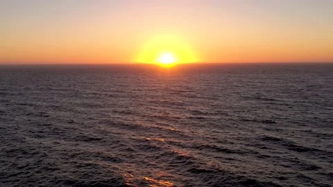 Aerial of the sun setting below the ocean horizon. Stock Footage 218350637