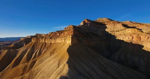 Aerial of sun setting on desert mountain ridge in Fruita, Colorado drone Stock Footage 82189296