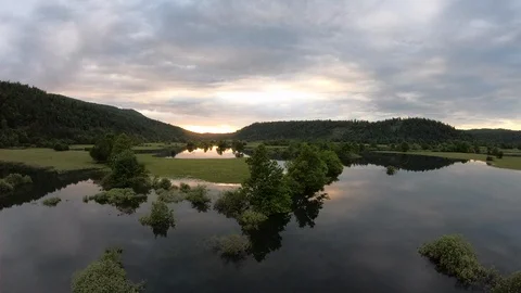 AERIAL Sun setting over the flooded peaceful valley Stock Footage 109345820