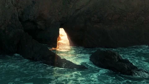 Aerial: Sun shining through open hole in a cliff. Mendocino Coast. USA Stock Footage 162263102