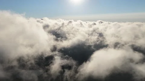 Aerial of Sunlit Clouds Drifting Through the Sky 動画素材 316552251
