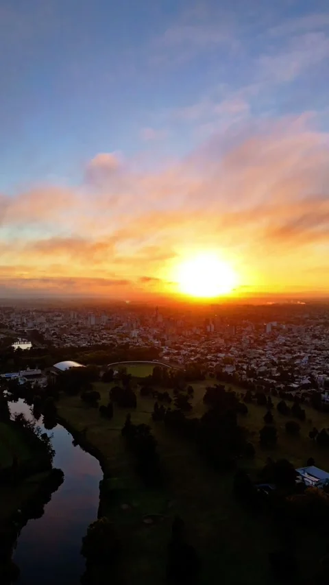 Aerial sunrise hyperlapse over a river, city and forest land Stock Footage 310847742