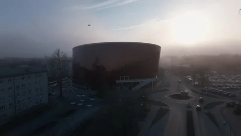 Aerial sunrise pullback over copper clad performance hall and roundabout Stock-Footage 337264457