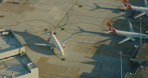 Aerial sunrise view Qantas aircraft taxiing Melbourne airport Stock Footage 91516470