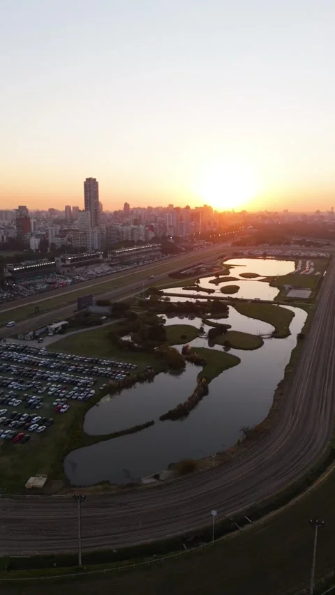 Aerial Sunrise View of Racetrack Complex and City With Parking Lot and Water Stock-Footage 334832593