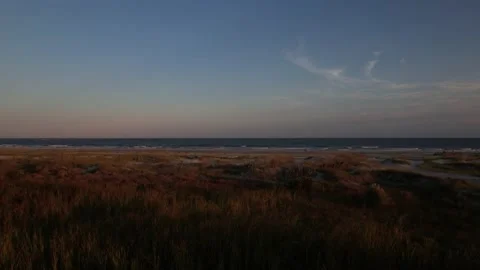 Aerial At Sunset On Beach Over Marsh and Dunes 5.4k and 24fps Stock Footage 209593359
