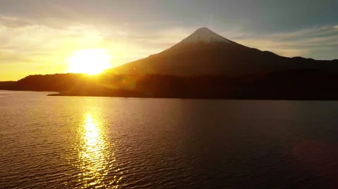 Aerial: Sunset behind volcano camera flying over ocean in Patagonia 스톡 동영상 64671579