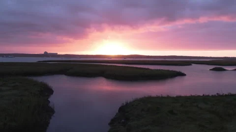 Aerial Sunset with Dramatic Sky Over Water Channels with Boats Docked Video stock 289845404