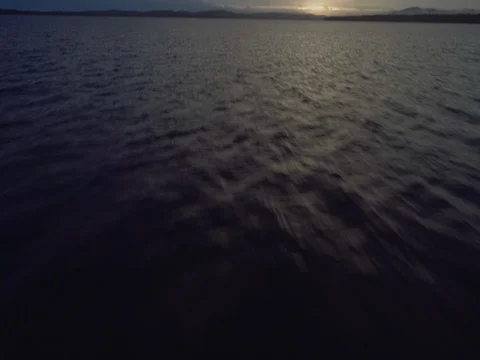 Aerial sunset flight tilting up over the lake at Mungo Brush National Park. Stock Footage 77818565