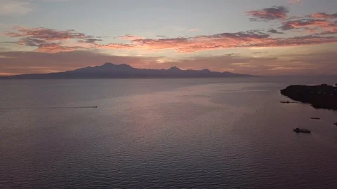 Aerial sunset flying down above the ocean on The Philippines Stock Footage 127181106