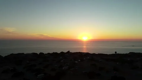 Aerial of sunset with ocean cliff Stock Footage 260270468
