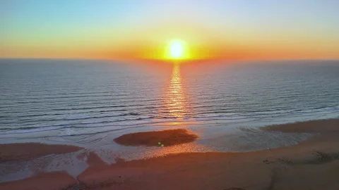 Aerial Sunset over Beach Heading out to Sea at Perranporth, Cornwall. Stock Footage 310135720