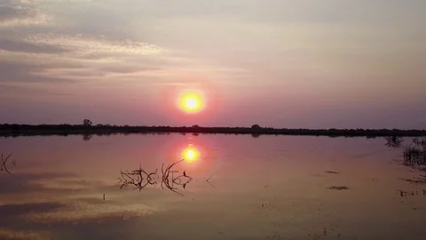 Aerial sunset over dam with birds flying Africa Stock Footage