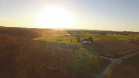 Aerial sunset over farm fields. Video stock 102779785
