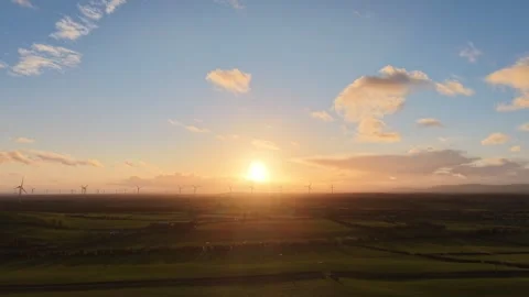 Aerial Sunset Over Green Fields and Wind Turbines in Rural Countryside Stock Footage 332431032