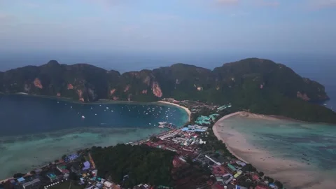 Aerial sunset over Koh Phi Phi isthmus with twin bays and boats Thailand Stock Footage 334350386