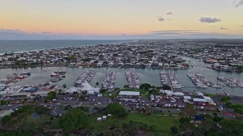 Aerial sunset over Mooloolaba Harbour marina and river channels, Sunshine C.. Stock Footage 333444564