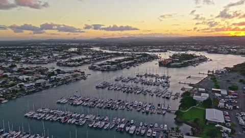Aerial sunset over Mooloolaba Harbour marina and river channels, Sunshine C.. Stock Footage 333444617