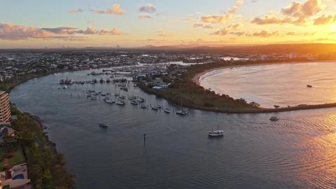 Aerial sunset over Mooloolaba Harbour marina and river channels, Sunshine C.. Video stock 333445600