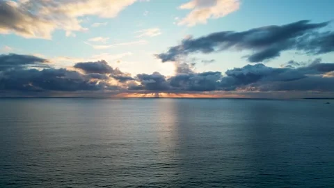 Aerial Sunset Over Ocean with Dramatic Clouds Stock Footage 307971173