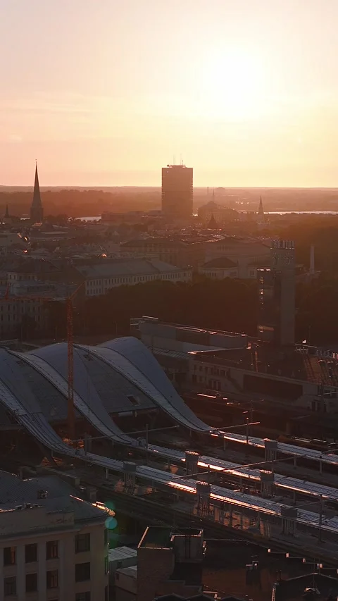 Aerial sunset over Riga Central Station, RIGA clock tower, Old Town 스톡 동영상 338036150