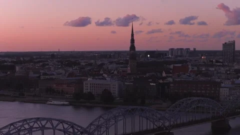 Aerial sunset over Riga with St. Peter's spire and Railway Bridge Stock Footage 340847624