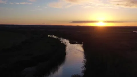 Aerial sunset over river with warm reflections and calm atmosphere Stock Footage 327452847