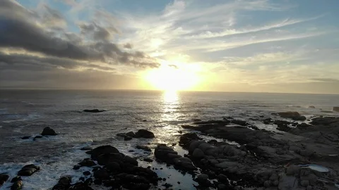 Aerial Sunset Over Rocks and Ocean Stock Footage 103100562