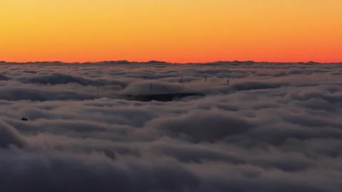 Aerial sunset over rolling clouds and wind turbines, Madeira Island Stock Footage 323447271