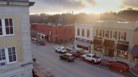 Aerial -  Sunset over Small Town America SUV drives down street Stock Footage 146700354