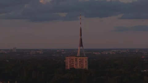 Aerial sunset pan of Riga TV Tower and Soviet block near Ziepniekkalns Stock Footage 337634275