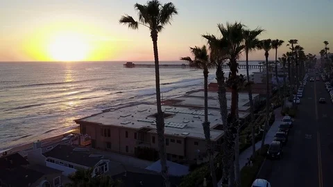 Aerial Sunset Pier Crane Down Reveal Palm Trees Stock Footage 77637074