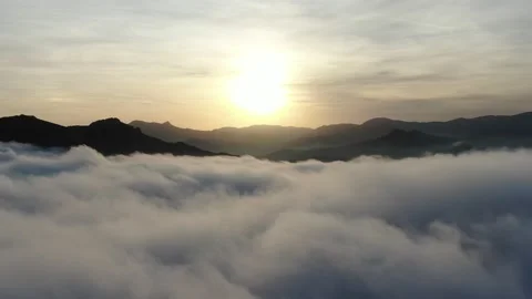 Aerial sunset shooting in the mountains where only the tops of the slopes in the Stock Footage 132169587