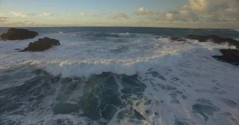Aerial sunset shot over waves on the northern California coast Stock Footage 81840422