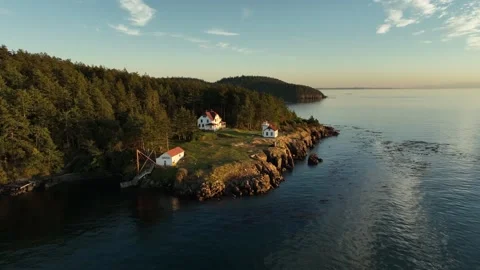 Aerial sunset view of the Burrows Island Lighthouse, Anacortes, Washington Stock Footage 310761069