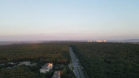 Aerial sunset view of city road near forest Stock Footage 337091253