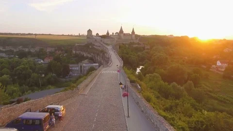 Aerial sunset view flying over bridge and road and over Kamianets castle 4k Stock Footage 78469979