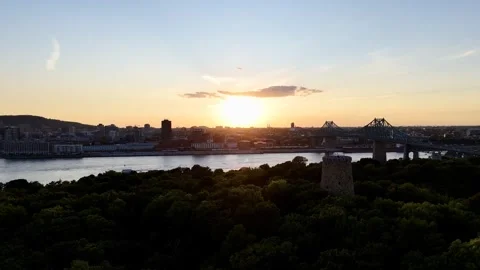 Aerial sunset view of Jacques Cartier Bridge over Saint Lawrence River in Stock Footage 346505358