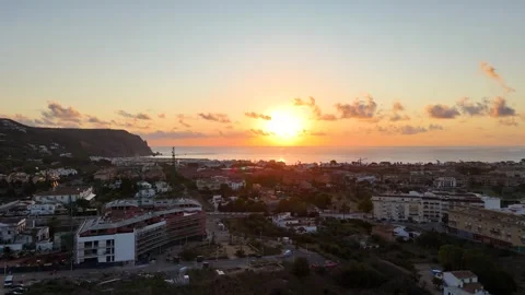 Aerial sunset view of Javea town development and Mediterranean cliffs 動画素材 337034586