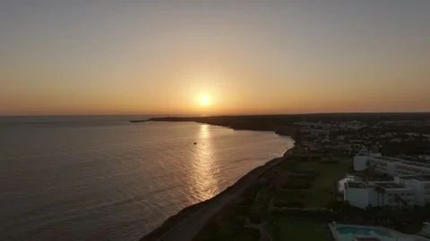 Aerial sunset view over Conil de la Frontera, Spain with golden reflections on Stock Footage 342473686