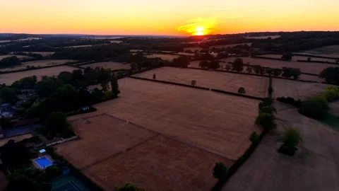 Aerial Sunset View Over Town And Rural Landscape With Orange Evening Sky Vidéo 341730613
