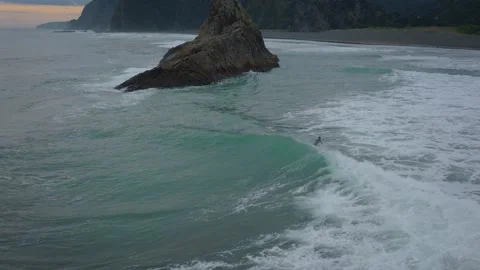 Aerial: Surfer Catching A Wave On Karekare Beach, Auckland, New Zealand Stock-Footage 201848804