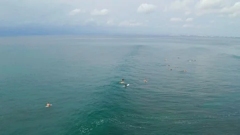 Aerial of surfers lining up in wave swell in Uluwatu Bali 4K Drone Footage Stock Footage 103222353