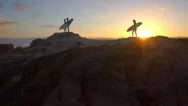 Aerial: Surfers Watching Waves At Sunset Stock Footage