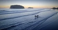 Aerial Of Surfers On Whangamata Beach And Clark Island At Sunset, Coromandel, Stock Footage