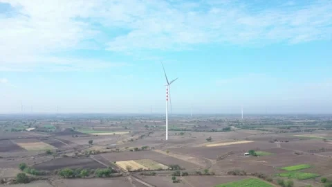 Aerial survey of crop fields and green patches within a dry rural terrain under Stock Footage 336465997