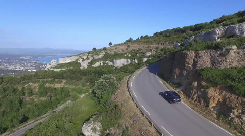 AERIAL: SUV car driving along the mountain road in France Stock Footage