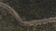 Aerial: Suv Car Driving Along The Winding Mountain Pass Road Through The Forest Stock Footage